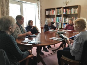 book group around library table. Photo by HelpStation
