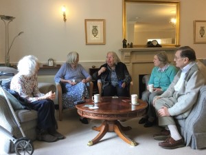 group of people having coffee in a lounge. Photo by HelpStation