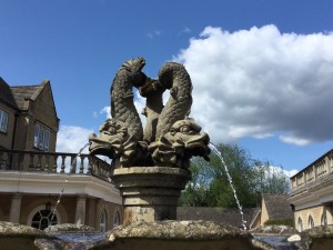 fountain closeup in summer with water trickling and blue sky. Photo by HelpStation