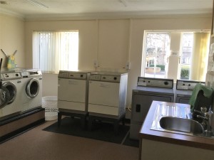 laundry showing washing machines and dryers. Photo by HelpStation